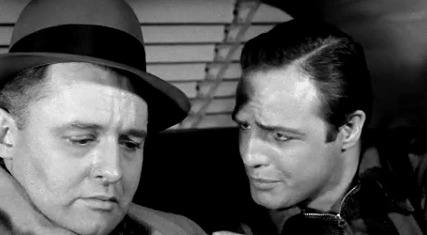 Marlon Brando and Rod Steiger in On the Waterfront (1954) — Brando in his iconic working-class leather jacket and cap